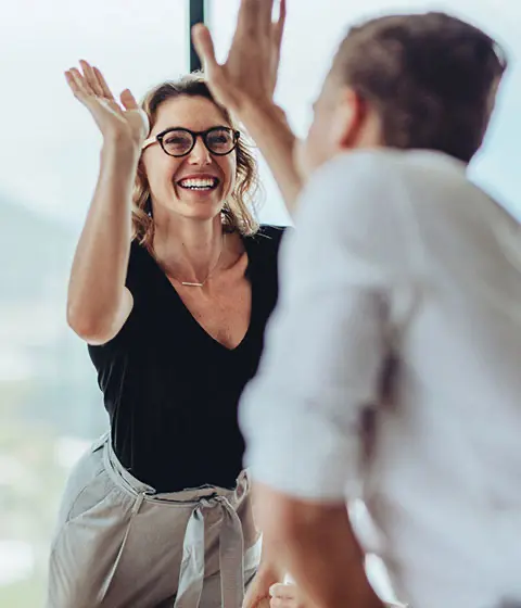Business colleagues celebrating successful debt recovery
