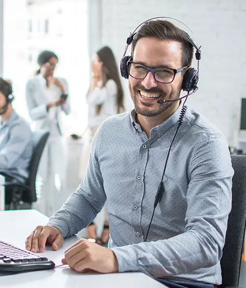Invoice collection professional smiling while working at a desk