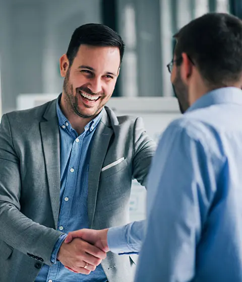 Business owner shaking hands with client after successful debt recovery