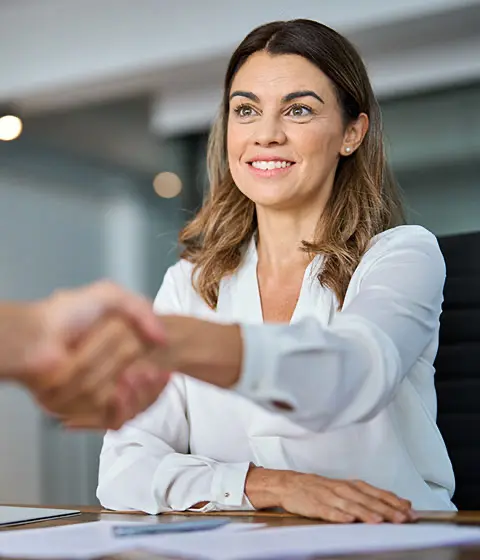 Debt recovery professional shaking hands with a business client